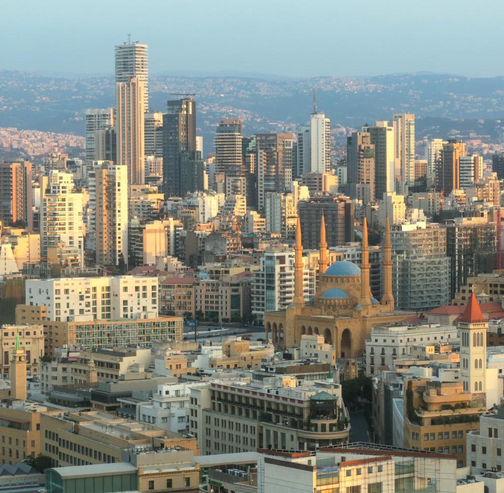 View on Beirut, Lebanon, with skyscrapers , mosques and churches. The big mosque is the Mohammad Al-Amin Mosque, also called here the Blue mosque. It was built from 2002-2008. Adjacent to the mosque is the St. George Maronite Cathedral with the new bell tower.