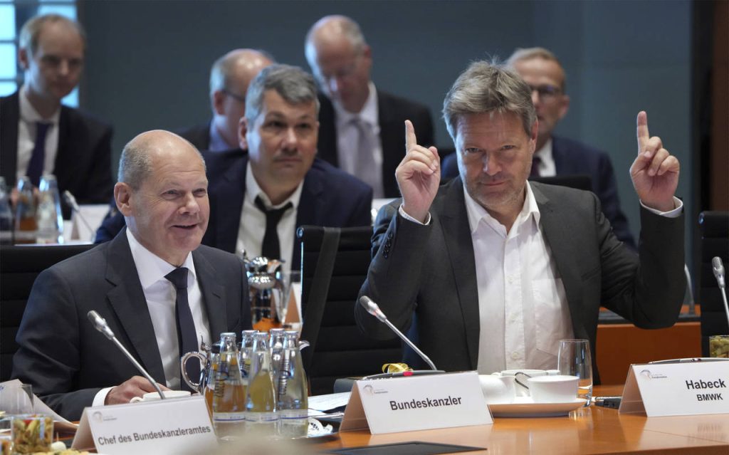 German Economy and Climate Minister Robert Habeck, front right, point up as German Chancellor Olaf ...